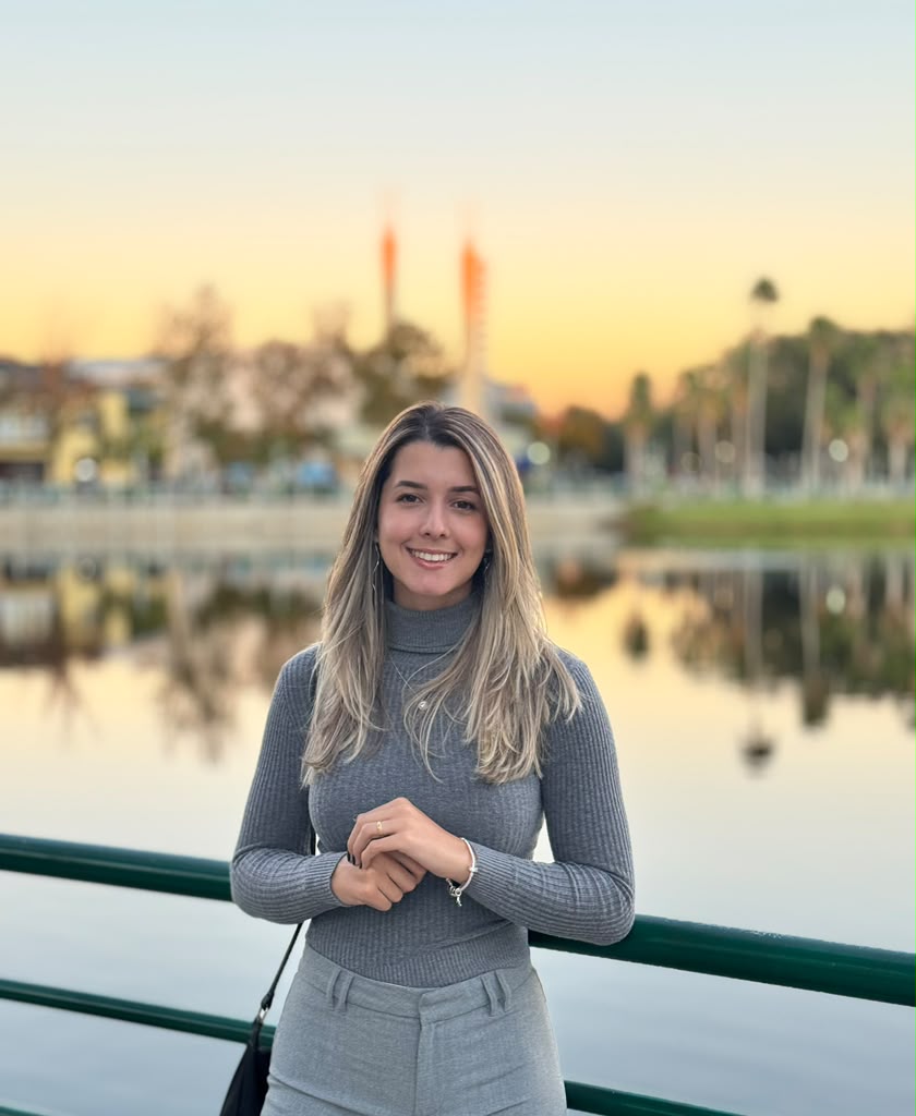 Julianna Goes, UGC creator, smiling outdoors at sunset by a lake in Florida